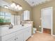 Bright bathroom with double vanity, large mirror, and glass enclosed shower offering a functional layout at 2825 Redfield Dr, Charlotte, NC 28270