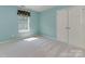 Bright bedroom features plush carpet, neutral walls, and a window for natural light at 2825 Redfield Dr, Charlotte, NC 28270