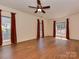 Spacious bedroom with hardwood floors and bright windows, offering ample natural light and a serene atmosphere at 2825 Redfield Dr, Charlotte, NC 28270