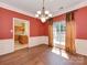 Dining room with hardwood floors, decorative lighting, and a view into the kitchen at 2825 Redfield Dr, Charlotte, NC 28270