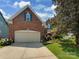Brick two-story home showing the garage, front lawn, driveway and blue shutters at 2825 Redfield Dr, Charlotte, NC 28270