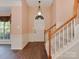 Inviting foyer with hardwood floors, staircase, wainscoting, and a view of the living space at 2825 Redfield Dr, Charlotte, NC 28270
