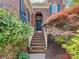 Charming brick home featuring an arched entryway, elegant black door, and beautifully landscaped front yard at 2825 Redfield Dr, Charlotte, NC 28270