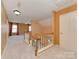 Upstairs hallway featuring carpeted floors, wood railings, and neutral paint at 2825 Redfield Dr, Charlotte, NC 28270