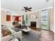 Spacious living room with hardwood floors, fireplace, ceiling fan, and natural light at 2825 Redfield Dr, Charlotte, NC 28270