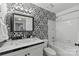 Unique bathroom boasts patterned wallpaper, tiled floors, and shower-tub combo at 300 E Park Ave # 16, Charlotte, NC 28203