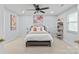 Light-filled bedroom features a ceiling fan, floral artwork, and a comfortable bed at 300 E Park Ave # 16, Charlotte, NC 28203