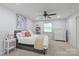 Serene bedroom features soft lighting, a ceiling fan, a comfortable bed and built-in shelves at 300 E Park Ave # 16, Charlotte, NC 28203