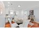 Bright dining area features hardwood floors, a glass table with white chairs, and flows into the updated kitchen at 300 E Park Ave # 16, Charlotte, NC 28203