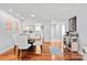 Dining area features hardwood floors and a glass table with seating, adjacent to the updated kitchen at 300 E Park Ave # 16, Charlotte, NC 28203