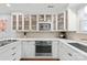 A stylish kitchen featuring white cabinets, stainless steel appliances, and hardwood floors at 300 E Park Ave # 16, Charlotte, NC 28203