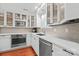 A modern kitchen featuring white cabinets, stainless steel appliances, and hardwood floors at 300 E Park Ave # 16, Charlotte, NC 28203