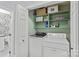 Functional laundry area with washer, dryer, and shelving for organized storage at 300 E Park Ave # 16, Charlotte, NC 28203