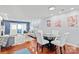Open-concept living and dining area with hardwood floors and access to an outdoor balcony at 300 E Park Ave # 16, Charlotte, NC 28203