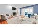 A stylish living room with a fireplace, modern furniture, and access to a balcony at 300 E Park Ave # 16, Charlotte, NC 28203