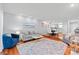 Open-concept living room with a plush sofa, stylish decor, hardwood floors, and access to the dining area at 300 E Park Ave # 16, Charlotte, NC 28203