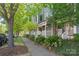 A sidewalk view shows a well-maintained community with lush landscaping and welcoming entrances at 300 E Park Ave # 16, Charlotte, NC 28203