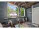 Charming sunroom with wood-paneled walls, bar seating, and views of the outdoors at 300 E Park Ave # 16, Charlotte, NC 28203