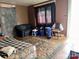 A small living room with hardwood floors, a couch and day bed in need of remodeling at 302 Melrose Sw Dr, Concord, NC 28025