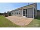 Enjoy outdoor living on this home's stone patio, complemented by a charming brick fireplace at 3073 Oliver Stanley Trl, Lancaster, SC 29720