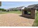 Relax in this backyard featuring a stone patio and brick fireplace ideal for outdoor entertaining at 3073 Oliver Stanley Trl, Lancaster, SC 29720