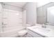 This bathroom features a tub with white tile surround and a marble vanity at 3073 Oliver Stanley Trl, Lancaster, SC 29720