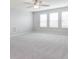 This spacious bonus room features neutral carpeting, a ceiling fan and lots of natural light at 3073 Oliver Stanley Trl, Lancaster, SC 29720