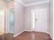 Bright entryway featuring wood floors, a white front door, and a view into another room at 3073 Oliver Stanley Trl, Lancaster, SC 29720