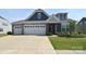 Charming two-story home with a three car garage, stone accents and a well-manicured lawn at 3073 Oliver Stanley Trl, Lancaster, SC 29720