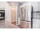 Kitchen area with stainless steel refrigerator, walk-in pantry and granite countertops at 3073 Oliver Stanley Trl, Lancaster, SC 29720