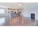 Open floor plan showcasing the living room with fireplace and adjacent kitchen with island at 3073 Oliver Stanley Trl, Lancaster, SC 29720