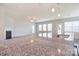 Open concept living area with fireplace, large windows, and granite counter with a sink at 3073 Oliver Stanley Trl, Lancaster, SC 29720