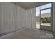 A sunroom features a covered ceiling with a curtain and a screen door to the exterior at 3073 Oliver Stanley Trl, Lancaster, SC 29720