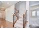 The staircase features wood and wrought iron spindles and neutral carpet at 3073 Oliver Stanley Trl, Lancaster, SC 29720