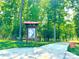 Beautiful walking trail with informational kiosk through a lush green forest leading to the lake at 3073 Oliver Stanley Trl, Lancaster, SC 29720