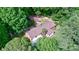 Aerial view of a charming home nestled among mature trees with a detached garage at 3116 Old Montgomery Place Rd, Monroe, NC 28112