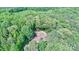 Aerial view of single Gathering house with detached garage nestled amongst mature trees at 3116 Old Montgomery Place Rd, Monroe, NC 28112