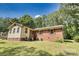 View of back exterior featuring back lawn and home with brick and vinyl siding at 3116 Old Montgomery Place Rd, Monroe, NC 28112