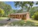 View of brick back exterior with covered patio and a well-maintained lawn at 3116 Old Montgomery Place Rd, Monroe, NC 28112