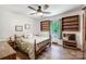 Bedroom with wood-style floors, ceiling fan, and shelves flanking the window at 3116 Old Montgomery Place Rd, Monroe, NC 28112