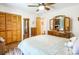 Bright bedroom with wood-style floors, ceiling fan and traditional wood furnishings at 3116 Old Montgomery Place Rd, Monroe, NC 28112