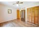 Bedroom with wood floors, ceiling fan, closet and light peach-colored walls at 3116 Old Montgomery Place Rd, Monroe, NC 28112