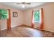 Cozy bedroom featuring hardwood floors, two windows and soft peach walls at 3116 Old Montgomery Place Rd, Monroe, NC 28112