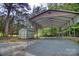 Large gravel driveway and carport with additional storage shed on a wooded lot at 3116 Old Montgomery Place Rd, Monroe, NC 28112