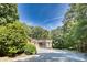Charming home with a long driveway, mature trees, and well-maintained landscaping at 3116 Old Montgomery Place Rd, Monroe, NC 28112