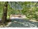 Charming home featuring a two-car garage, front porch, and a spacious driveway surrounded by mature trees at 3116 Old Montgomery Place Rd, Monroe, NC 28112