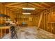 Spacious wooden garage interior with exposed beams and fluorescent lighting provides ample storage at 3116 Old Montgomery Place Rd, Monroe, NC 28112