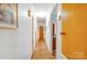 Hallway with neutral walls, wood flooring and access to multiple rooms at 3116 Old Montgomery Place Rd, Monroe, NC 28112