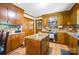 Traditional eat-in kitchen featuring wood cabinets, wood flooring and an island with marble countertops at 3116 Old Montgomery Place Rd, Monroe, NC 28112