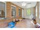 Sunroom with natural light, brick wall, and view of the surrounding trees at 3116 Old Montgomery Place Rd, Monroe, NC 28112